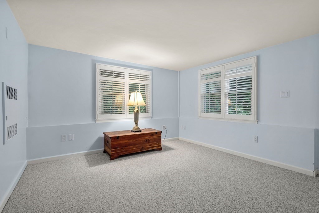 83 Pine Street Natick, MA 01760 - Photo 20 of 28 a living room with a window and a lamp