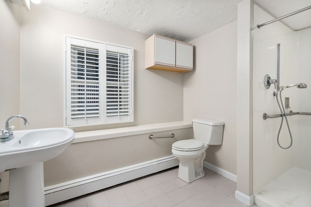 83 Pine Street Natick, MA 01760 - Photo 21 of 28 a bathroom with a sink and a toilet
