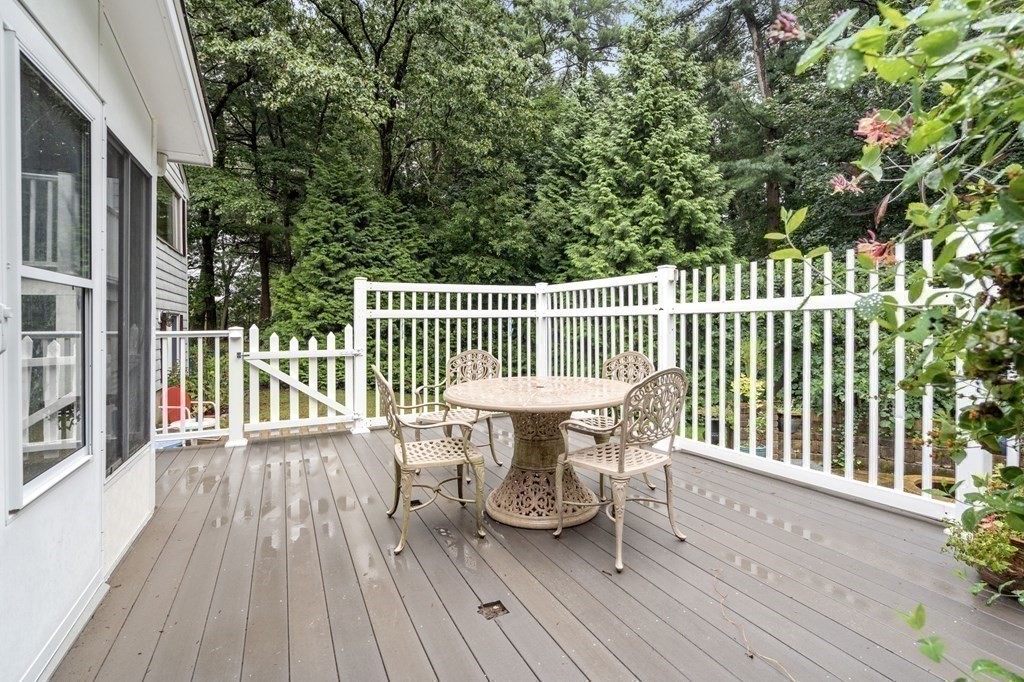 83 Pine Street Natick, MA 01760 - Photo 22 of 28 a view of a chair and table on the wooden deck