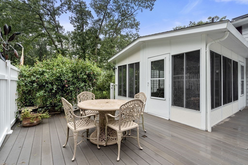 83 Pine Street Natick, MA 01760 - Photo 23 of 28 a table and chairs in front of a house