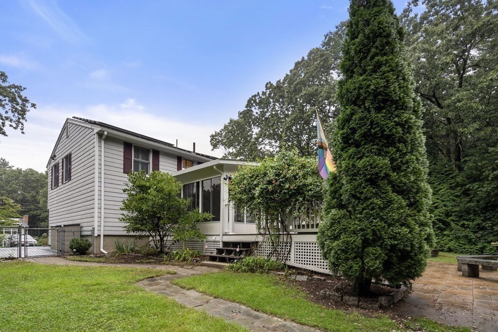 83 Pine Street Natick, MA 01760 - Photo 26 of 28 a front view of a house with a yard and tree