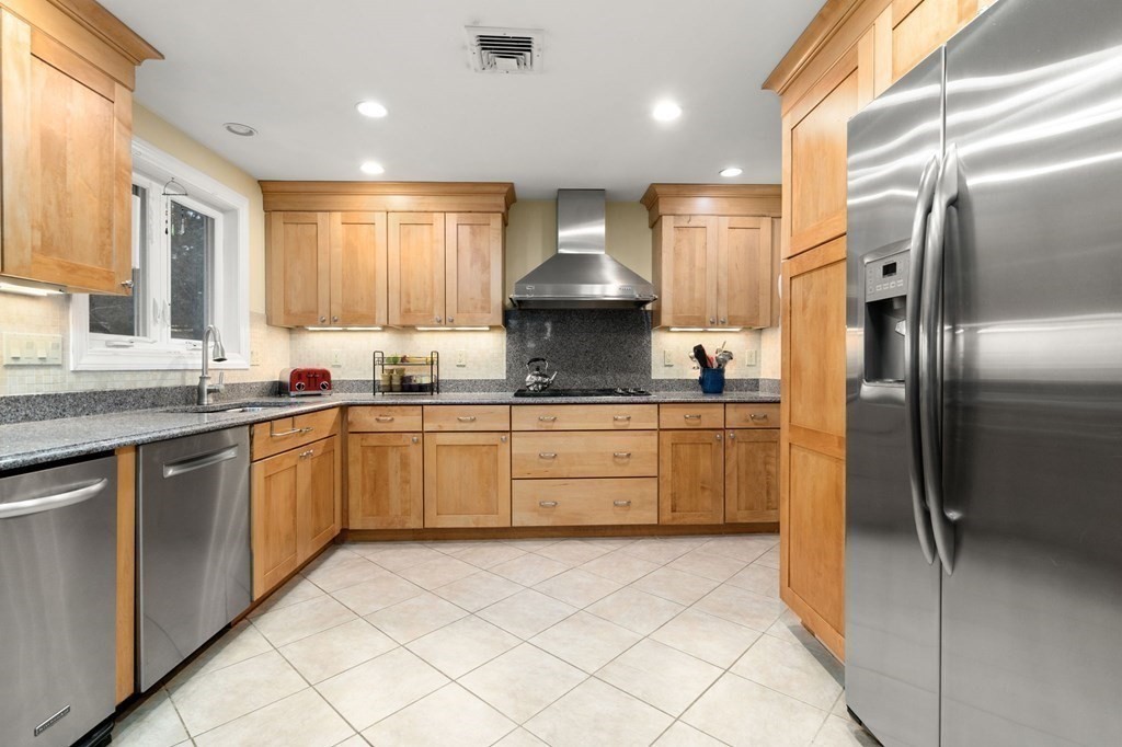 83 Pine Street Natick, MA 01760 - Photo 5 of 28 a kitchen with stainless steel appliances granite countertop a refrigerator sink and cabinets