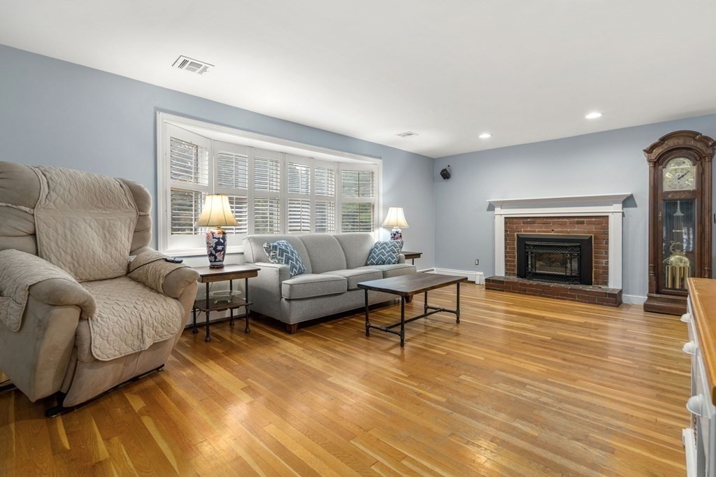 83 Pine Street Natick, MA 01760 - Photo 7 of 28 a living room with furniture and a fireplace