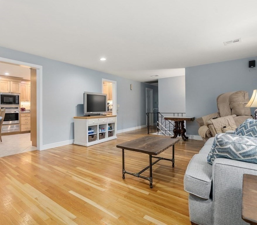 83 Pine Street Natick, MA 01760 - Photo 8 of 28 a living room with furniture and a flat screen tv