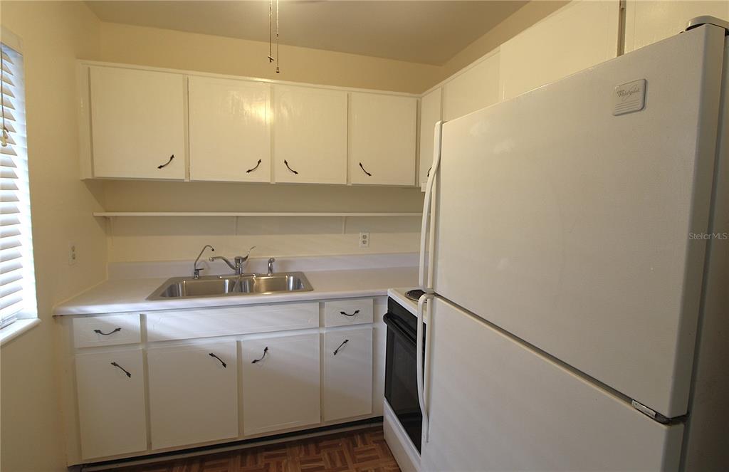 3101 Bee Ridge Road, Unit 209 Sarasota, FL 34239 - Photo 6 of 17 a view of cabinets and wooden floor