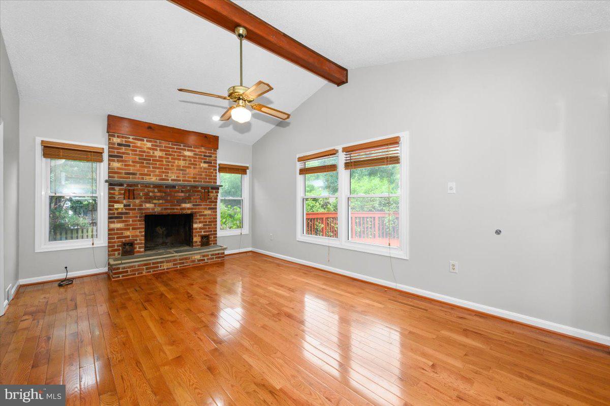 11110 Rock Road Rockville, MD 20852 - Photo 13 of 101 Family room with beamed ceiling and fireplace