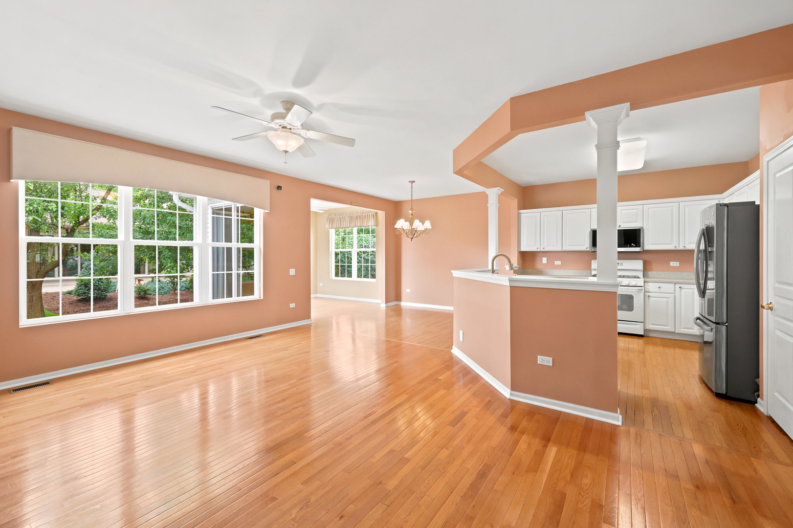 11923 Harrison Road Huntley, IL 60142 - Photo 5 of 38 a view of a kitchen with furniture a ceiling fan and wooden floor