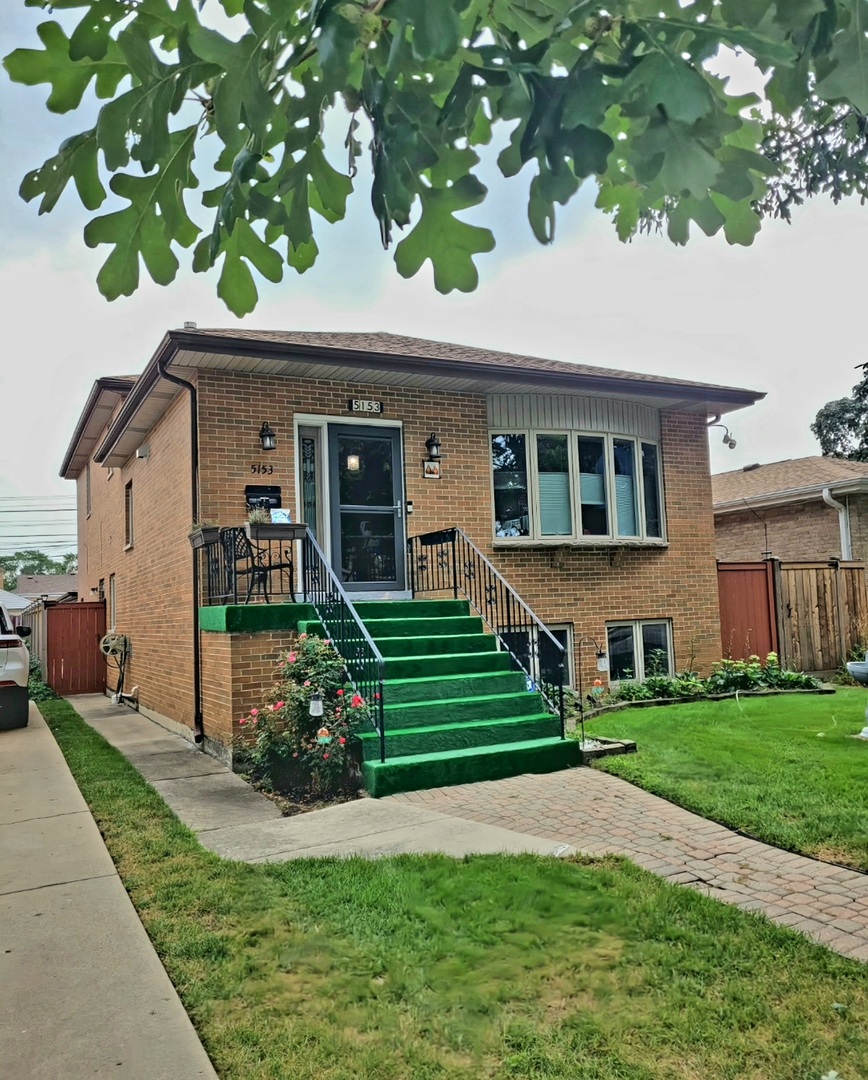 5153 Dobson Street Skokie, IL 60077 - Photo 1 of 27 a front view of a house with a yard