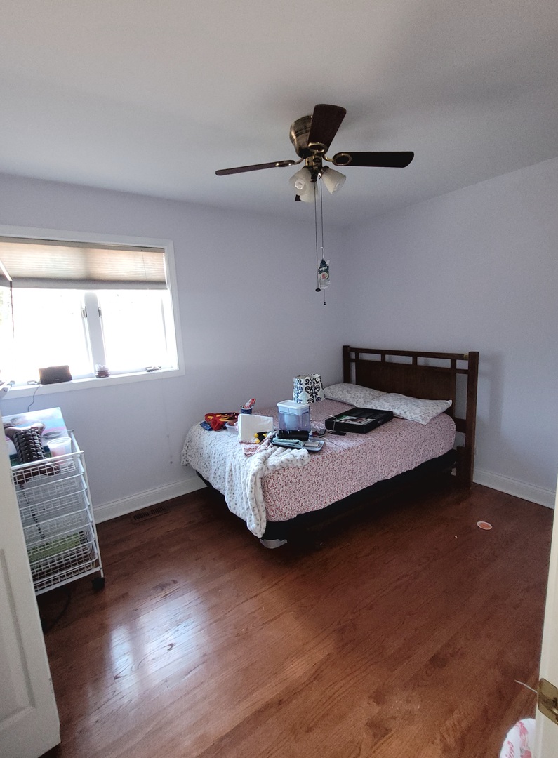 5153 Dobson Street Skokie, IL 60077 - Photo 16 of 27 a bedroom with bed and window