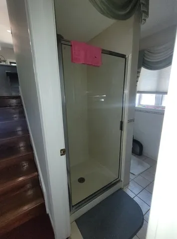 a bathroom with a glass shower door