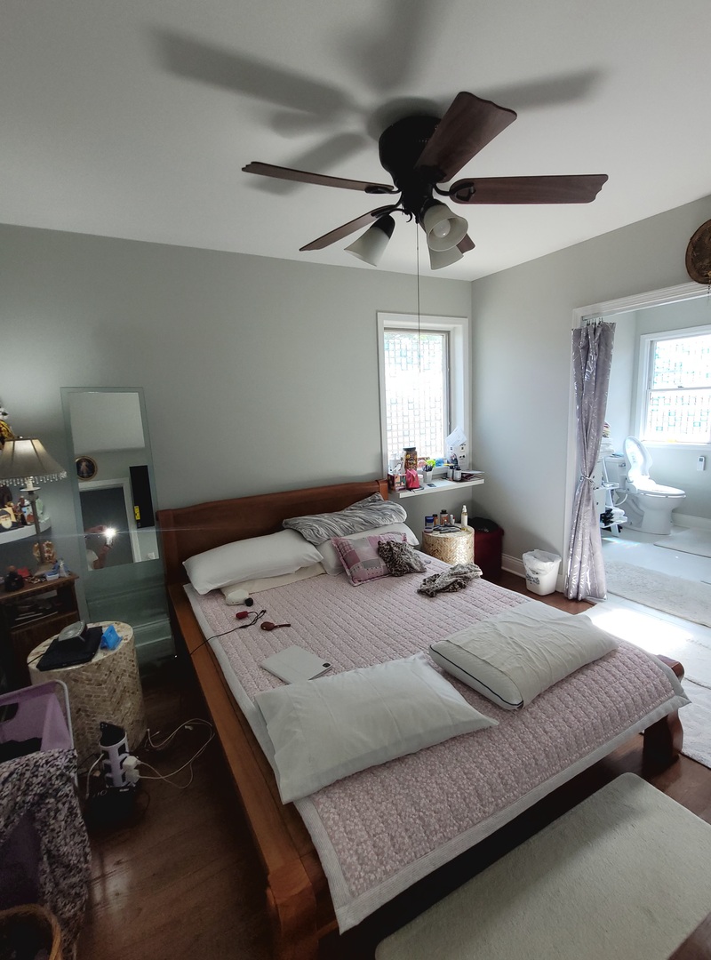 5153 Dobson Street Skokie, IL 60077 - Photo 18 of 27 a bed room with a bed window and a chandelier