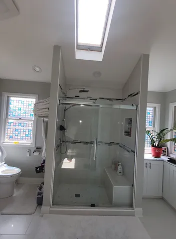 a bathroom with a sink toilet and shower