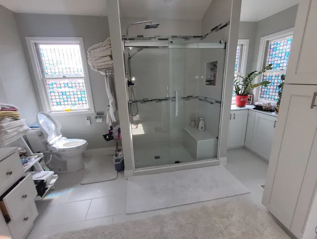 a bathroom with a shower and a toilet