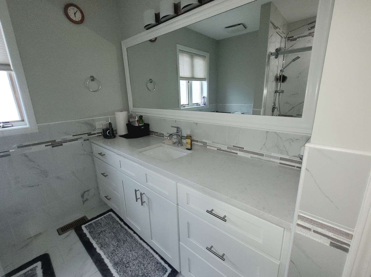 5153 Dobson Street Skokie, IL 60077 - Photo 24 of 27 a bathroom with a sink and a mirror
