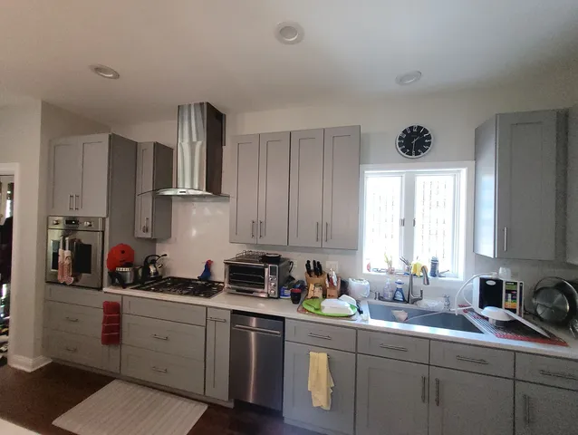 a kitchen with a sink cabinets and window