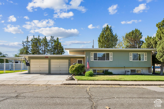 425 West 825 North Sunset, UT 84015 - Photo 1 of 1 View of front of property featuring concrete driveway and a garage