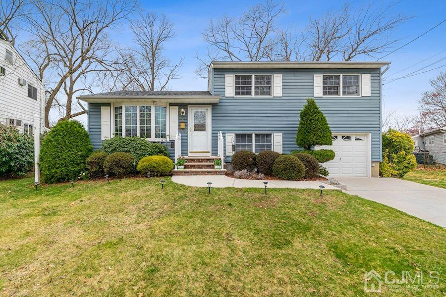 4 Finley Road Edison, NJ 08817 - Photo 1 of 32 a front view of a house with garden