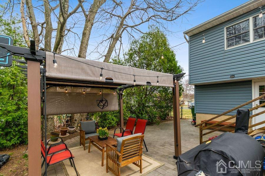 4 Finley Road Edison, NJ 08817 - Photo 27 of 32 a backyard of a house with outdoor seating