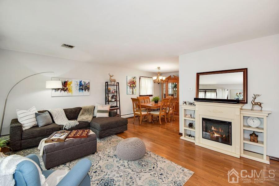 4 Finley Road Edison, NJ 08817 - Photo 4 of 32 a living room with furniture a flat screen tv and a fireplace