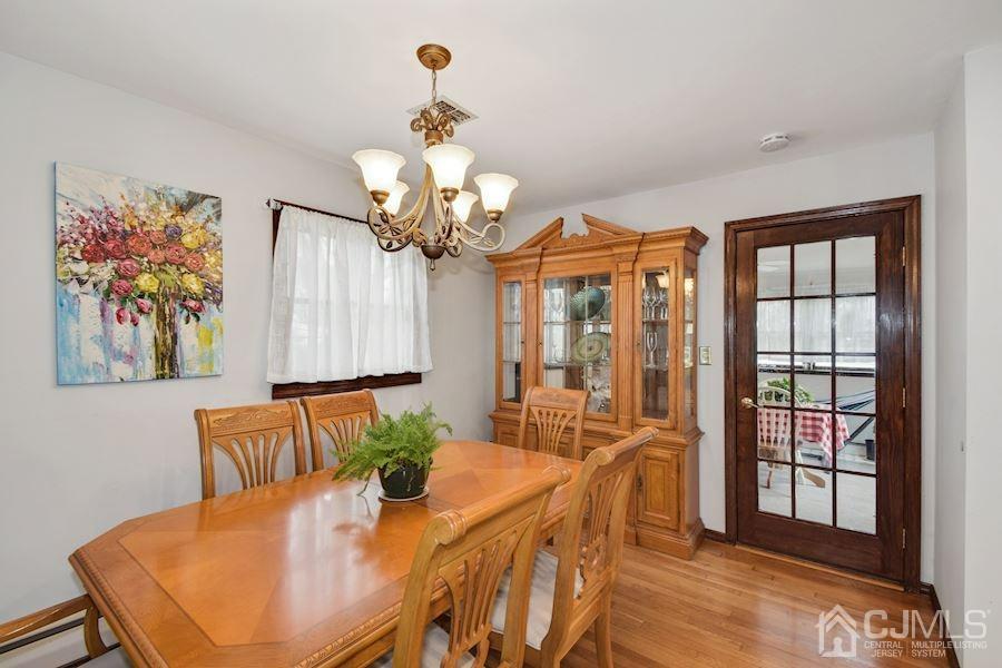 4 Finley Road Edison, NJ 08817 - Photo 7 of 32 a view of a dining room with furniture a chandelier and wooden floor