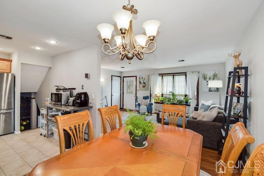 4 Finley Road Edison, NJ 08817 - Photo 9 of 32 a view of a dining room with furniture a chandelier and large windows