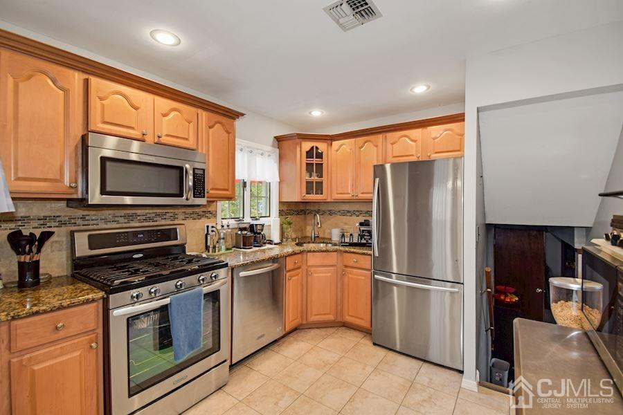4 Finley Road Edison, NJ 08817 - Photo 10 of 32 a kitchen with stainless steel appliances a refrigerator stove and microwave