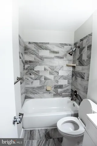 a bathroom with a sink a toilet and bathtub