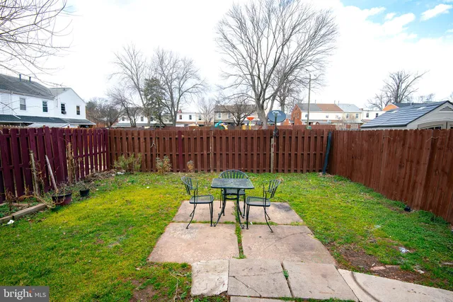 a view of a backyard with wooden fence
