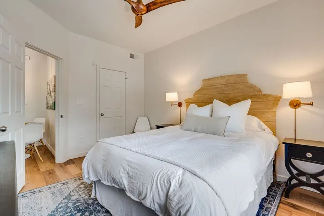 a bedroom with a bed and wooden floor