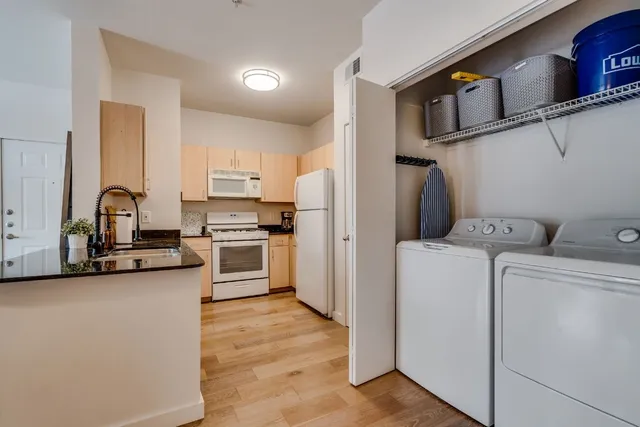 a kitchen with a stove cabinets and a sink