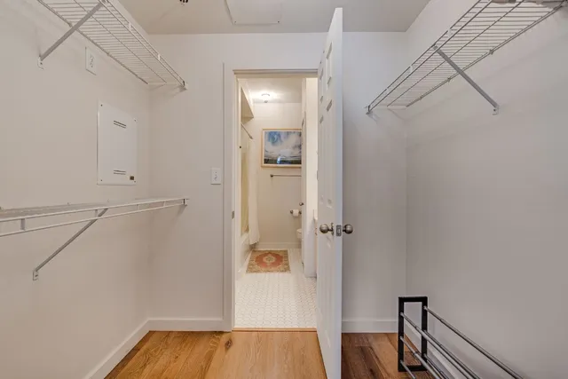 a view of a hallway with wooden floor