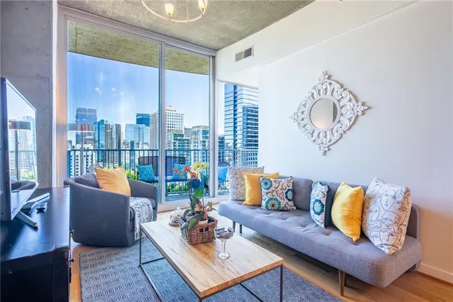 a living room with furniture and a large window