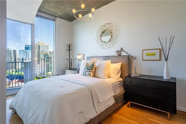 a bedroom with a bed and a chandelier