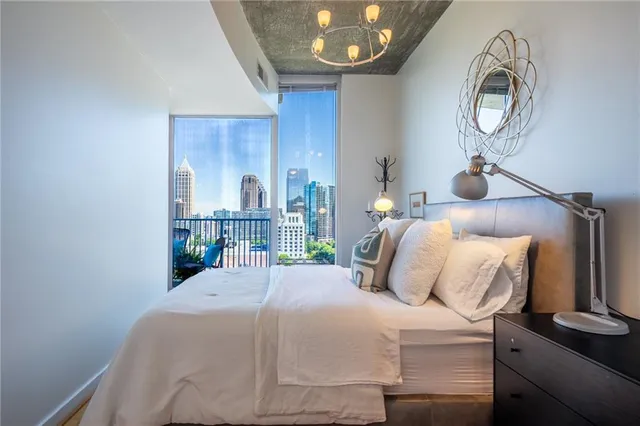 a bedroom with bed and a chandelier