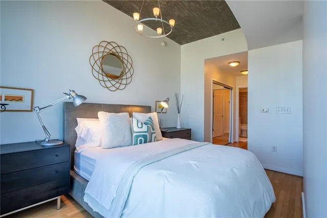 a bedroom with a bed and a chandelier