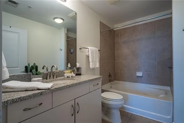 a white bath tub sitting next to a white toilet and a shower