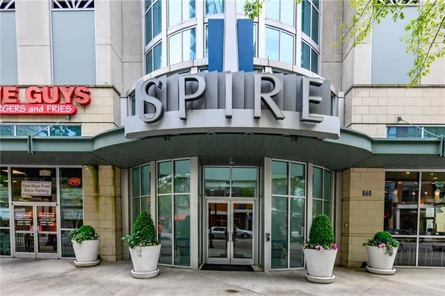 a view of a building with a large window and a plants