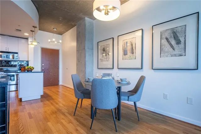 a view of a dining room with furniture and wooden floor