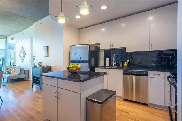 a kitchen with stainless steel appliances a sink stove and refrigerator