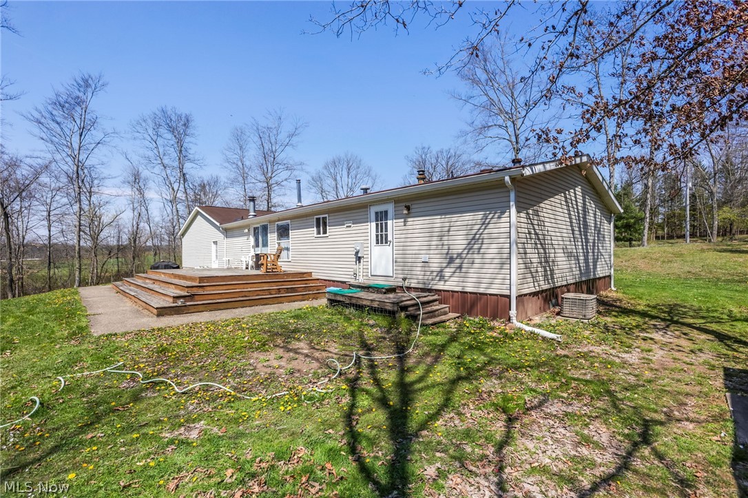 4502 Clover Road Cumberland, OH 43732 - Photo 4 of 38 Back of property featuring a yard and a wooden deck