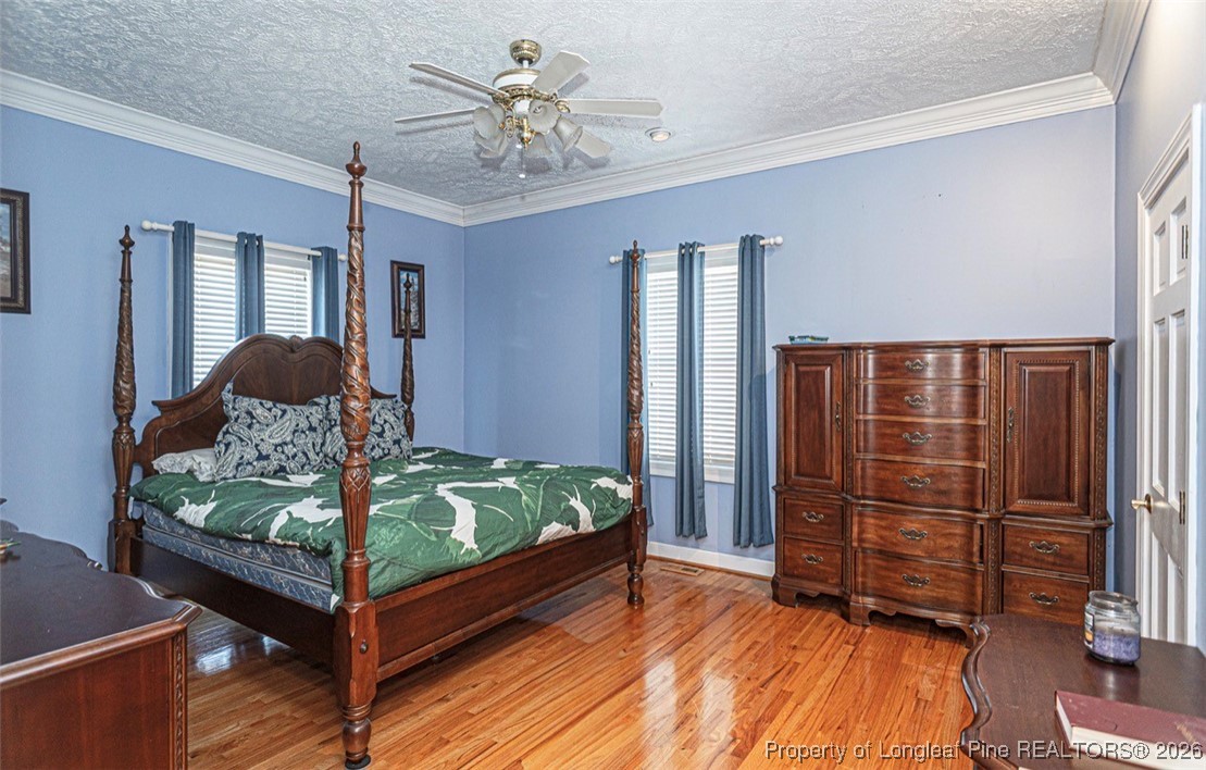 405 South Bond Street Rowland, NC 28383 - Photo 12 of 19 a bedroom with a bed and wooden floor