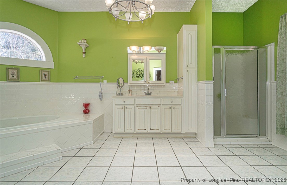 405 South Bond Street Rowland, NC 28383 - Photo 13 of 19 a bathroom with a sink mirror and a bathtub