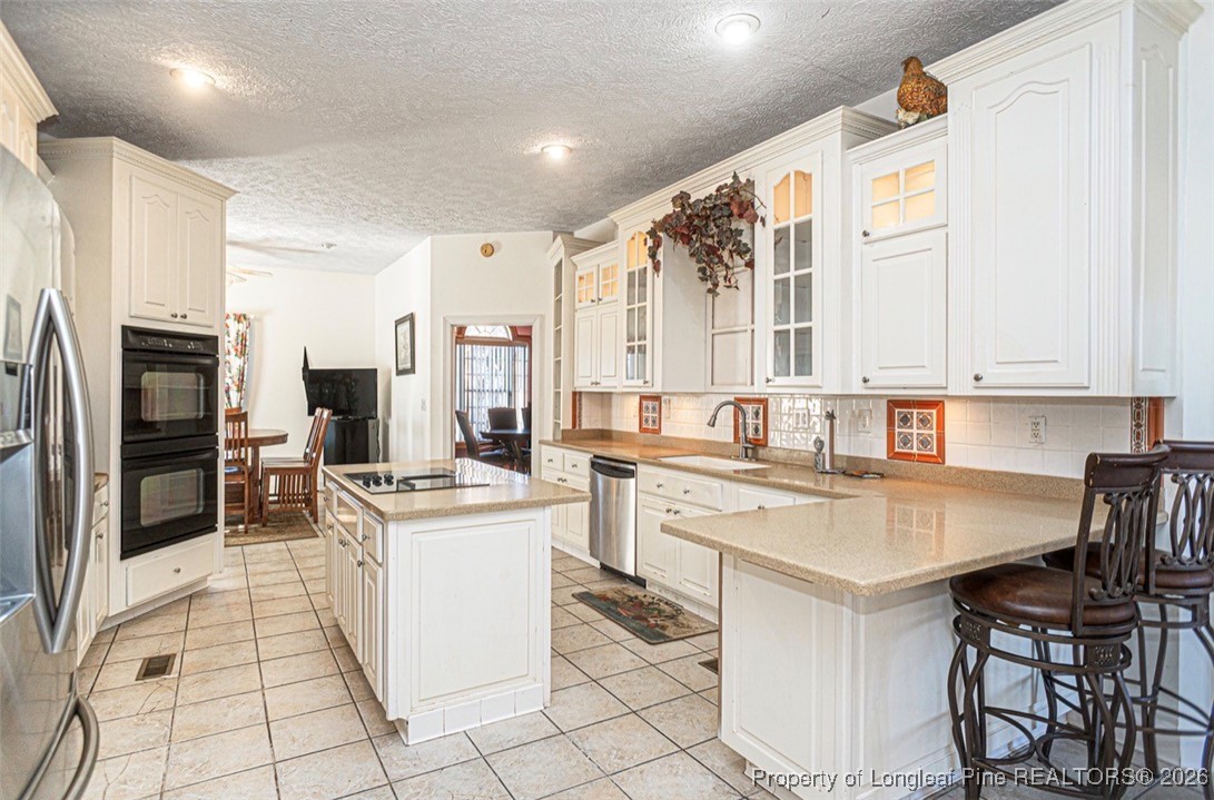 405 South Bond Street Rowland, NC 28383 - Photo 3 of 19 a kitchen with appliances a sink and cabinets