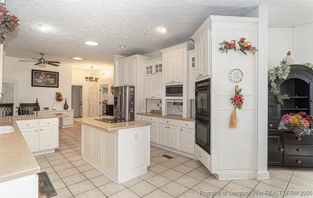 a kitchen with stainless steel appliances a refrigerator sink and cabinets