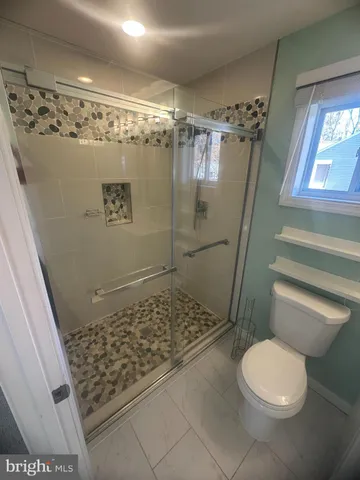 a bathroom with a toilet and shower