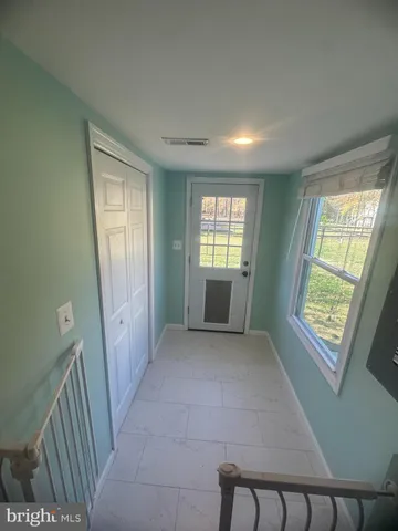 a view of livingroom with kitchen and window