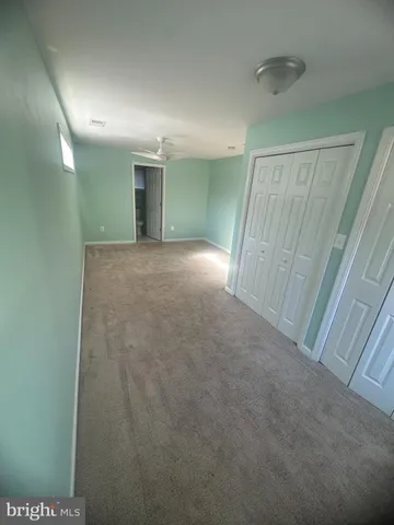 a view of a big room with closet and refrigerator