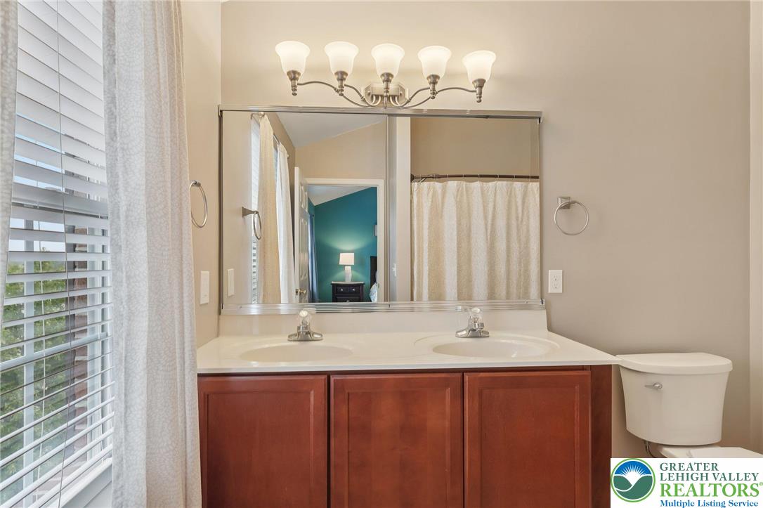 5192 Spring Ridge Drive East Macungie, PA 18062 - Photo 13 of 22 a bathroom with a sink a toilet and a mirror