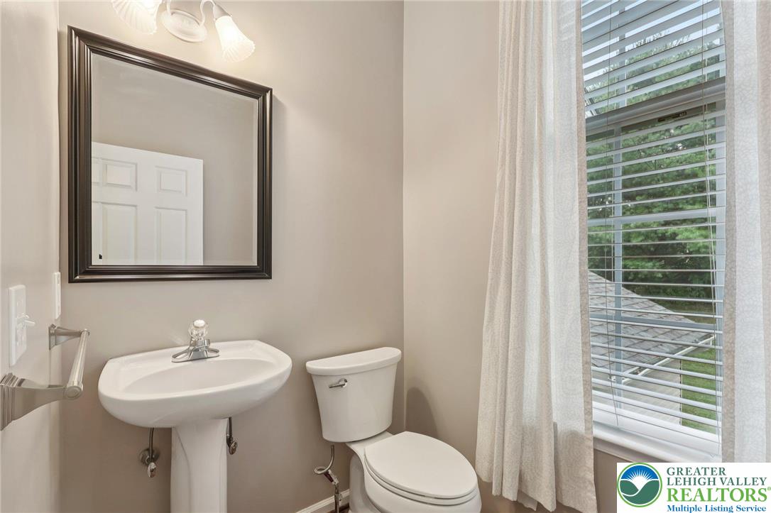 5192 Spring Ridge Drive East Macungie, PA 18062 - Photo 9 of 22 a bathroom with a sink a toilet and mirror