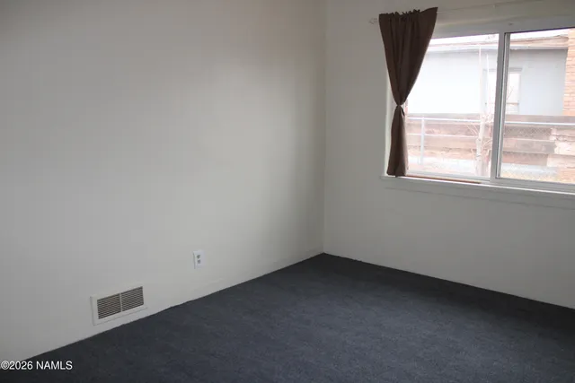 an empty room with wooden floor